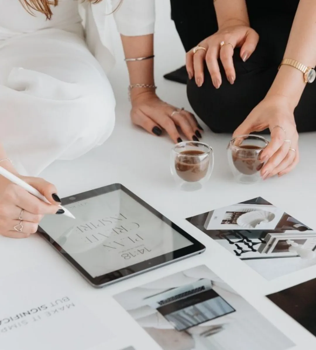 Team meeting with coffee and a tablet on the table